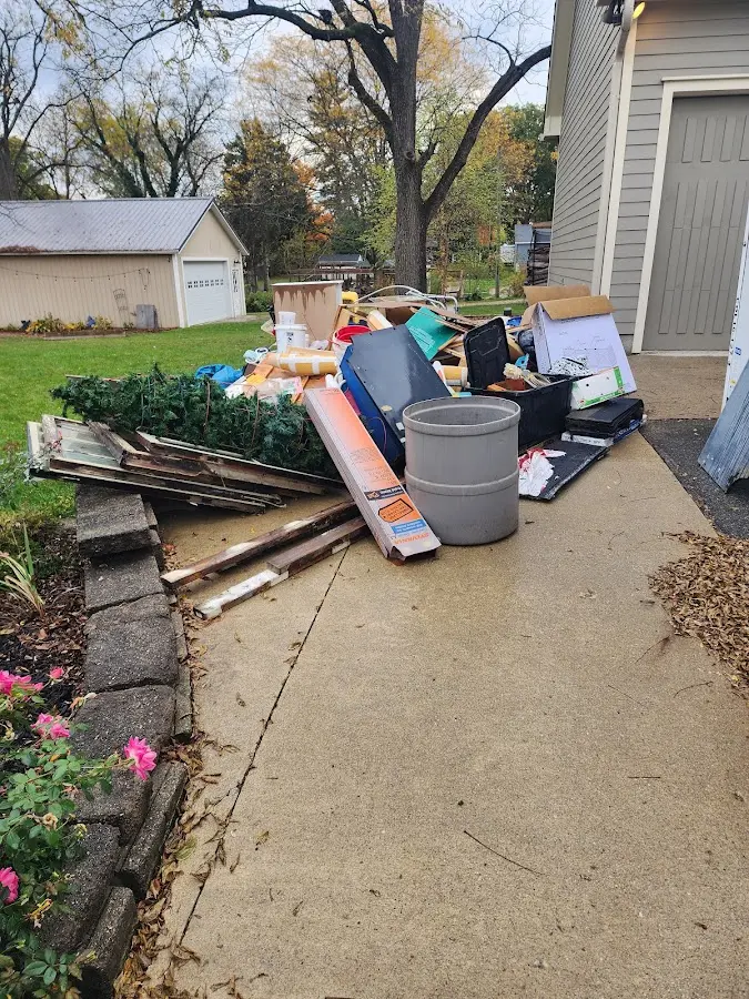 Dumpster being loaded with debris for Estate Cleanout Dumpster Rental in Hightstown